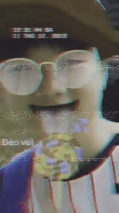 Person In Glasses And Hat Eating Candy Bar GIF