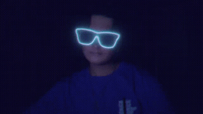 Person In Glow In The Dark Glasses And Blue Shirt With Letter B GIF