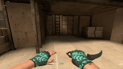 Person In Green Gloves Holding Knife In Warehouse GIF