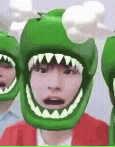 Person In Green Helmet With Sharp Teeth GIF