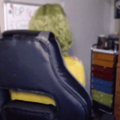 Person In Green Wig Sitting In Black Chair GIF