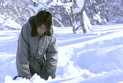 Person In Grey Jacket Kneeling In Snow GIF