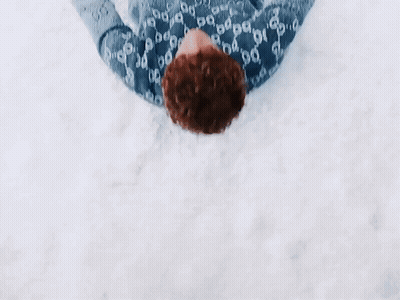 Person In Gucci Sweater Lying In Snow GIF