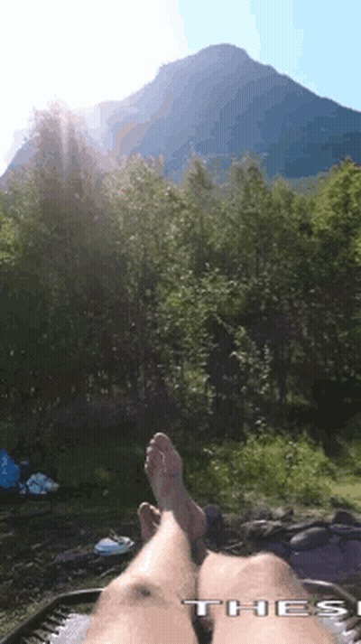 Person In Hammock With Feet Up Before Mountain GIF