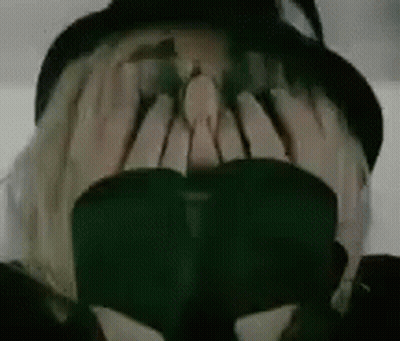 Person In Hat And Sunglasses Covering Face GIF