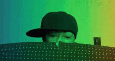 Person In Hat Looking Over Polka Dot Blanket GIF