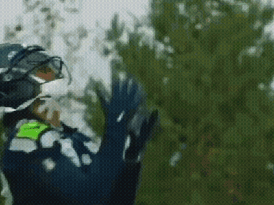 Person In Helmet And Gloves Waving GIF
