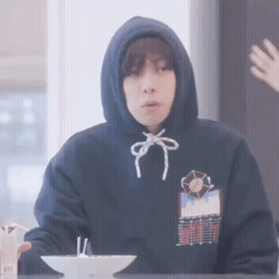 Person In Hoodie Sitting At Table With Bowl Of Food GIF