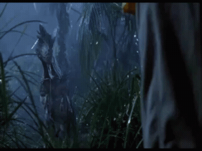 Person In Jungle With Dinosaur Statue GIF