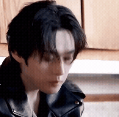 Person In Leather Jacket Looking Down GIF