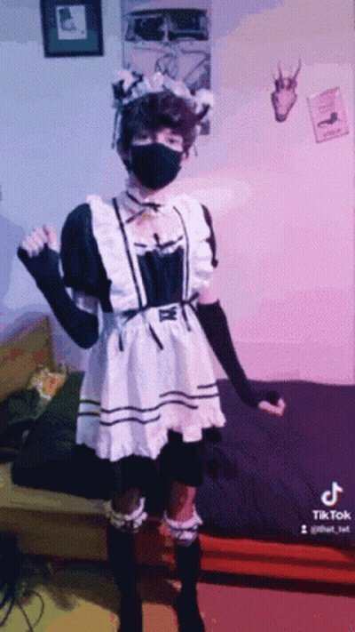 Person In Maid Costume And Black Mask GIF