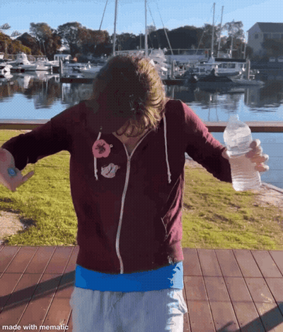 Person In Maroon Hoodie Holding Water Bottle GIF