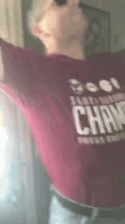 Person In Maroon Shirt Saying Champions GIF