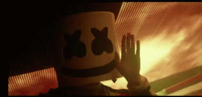 Person in Marshmallow Hat Waving by Fire