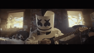 Person In Marshmallow Mask Playing Guitar In Bedroom GIF