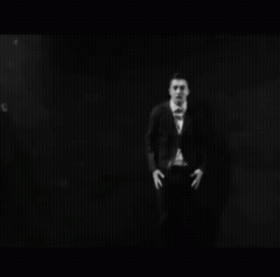 Person In Mask Making Heart Hands At Microphone GIF