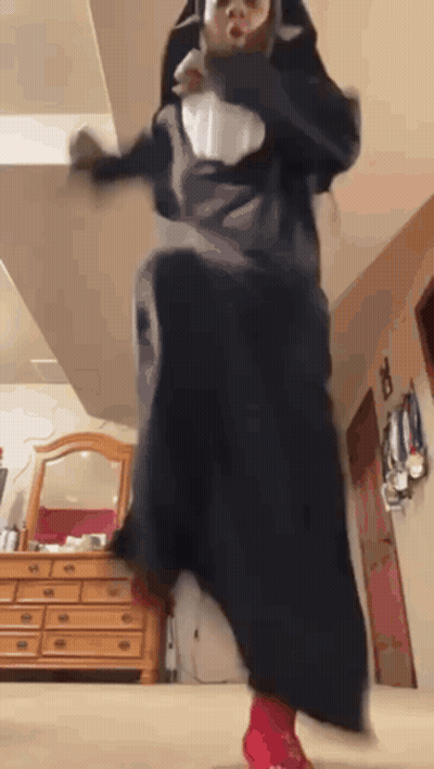 Person In Nun Costume Jumping GIF