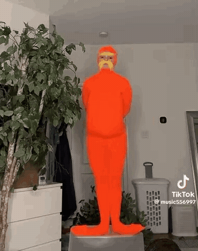 Person In Orange Costume With Mustache On Stool GIF