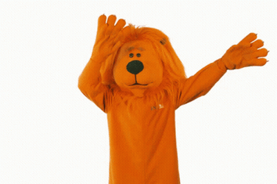 Person in Orange Lion Costume With Confetti