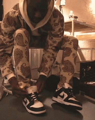 Person In Paisley Pants Tying Shoes GIF