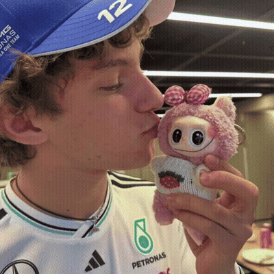 Person In Petronas Shirt Kissing Stuffed Animal GIF