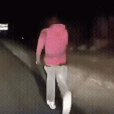 Person In Pink Hoodie Walking At Night GIF