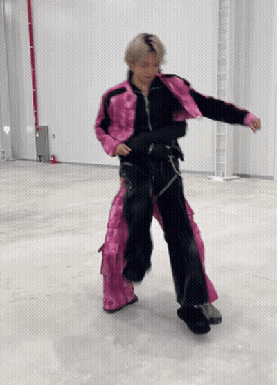 Person In Pink Jacket And Black Pants Dancing GIF