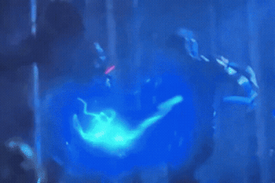 Person In Pink Mask Holding Sword In Dark GIF