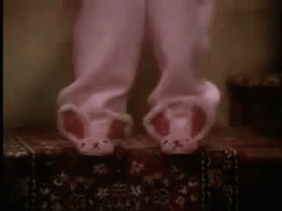 Person In Pink Pajamas And Bunny Slippers On A Box GIF