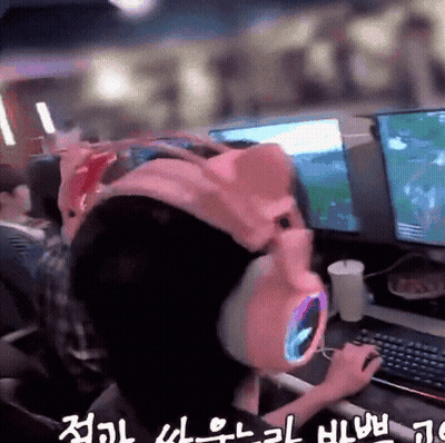 Person In Pink Pig Hat Playing Video Game GIF