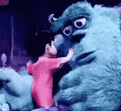 Person In Pink Shirt Hugging Stuffed Monster GIF