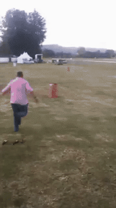 Person In Pink Shirt Running In Field GIF