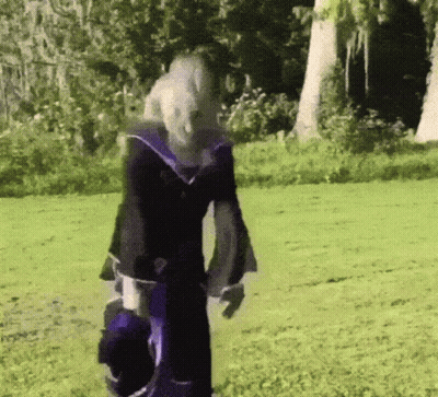 Person In Purple And Black Outfit In Grassy Field GIF