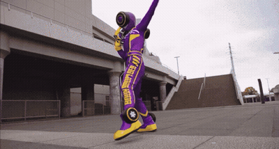 Person In Purple And Yellow Feel Good Rider Costume GIF