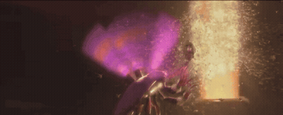 Person In Purple Cape Standing In Front Of Door With Purple Light GIF