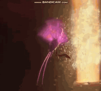 Person In Purple Cape Standing In Front Of Door With Purple Light GIF