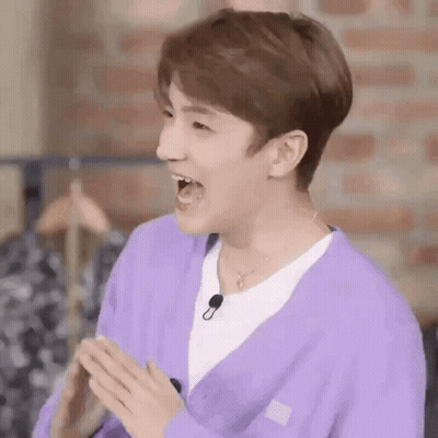 Person in Purple Cardigan White Shirt Mouth Open