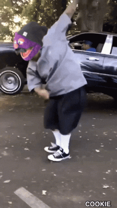 Person In Purple Mask And Beanie Dancing By Car Saying Cookie GIF
