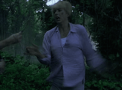 Person In Purple Shirt Standing In Green Forest GIF