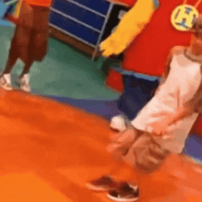 Person In Red And Yellow Costume Beside Child In White GIF