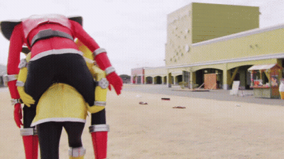 Person In Red And Yellow Costume Carrying Another Person GIF