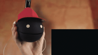 Person In Red Hat Holding Black Ball With Face GIF