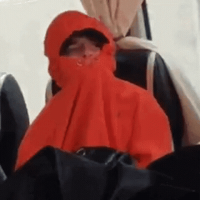 Person In Red Hooded Jacket Sitting On Chair GIF