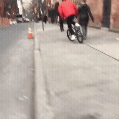 Person In Red Jacket Riding Bike GIF