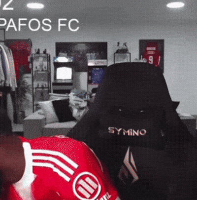 Person In Red Pafos FC Jersey In Gaming Chair GIF