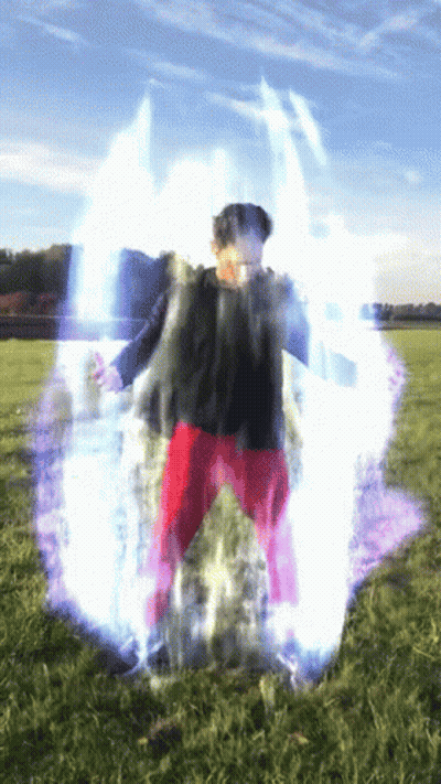 Person in Red Pants Standing in Field With Blue Light