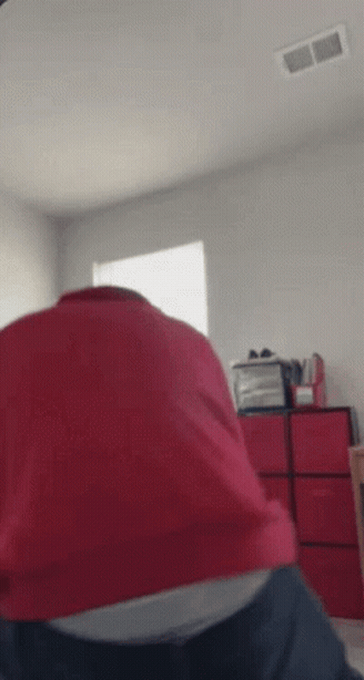 Person in Red Shirt Sitting on Bed With Red Drawers