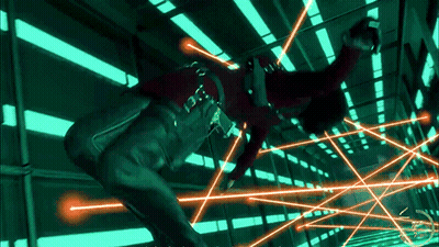 Person In Red Shirt Surrounded By Green And Orange Lights GIF