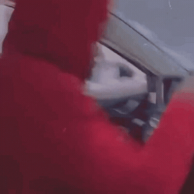 Person In Red Sweater Driving And Pointing At Steering Wheel GIF