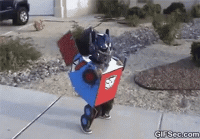 Person In Robot Costume Walking Down Sidewalk GIF
